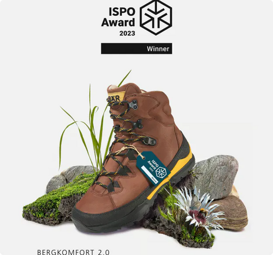 Brauner Wanderstiefel Bergkomfort 2.0 mit ISPO Award 2023, dekoriert mit Pflanzen und Steinen